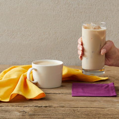 Oregon Chai next to measuring cup showing 32 oz bottle size and serving yield