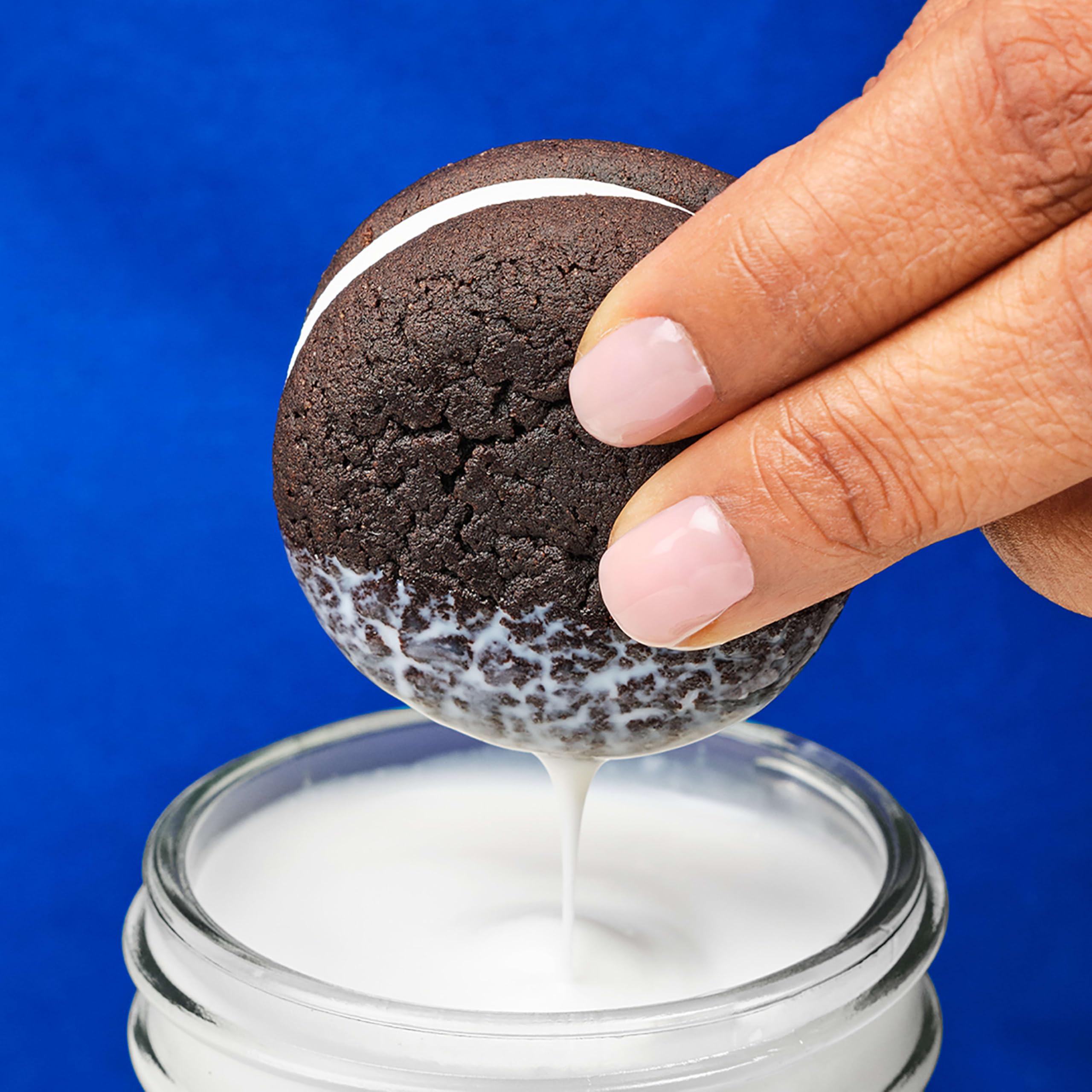 OREO held in hand for size comparison and portion guidance on servings