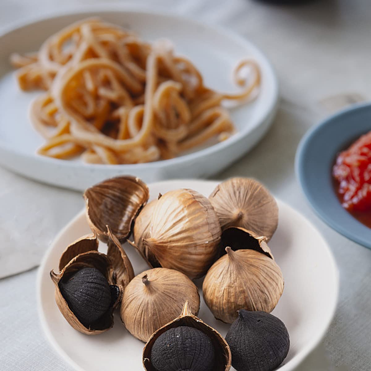 orsky black garlic open jar with serving spoon demonstrating ready-to-eat use