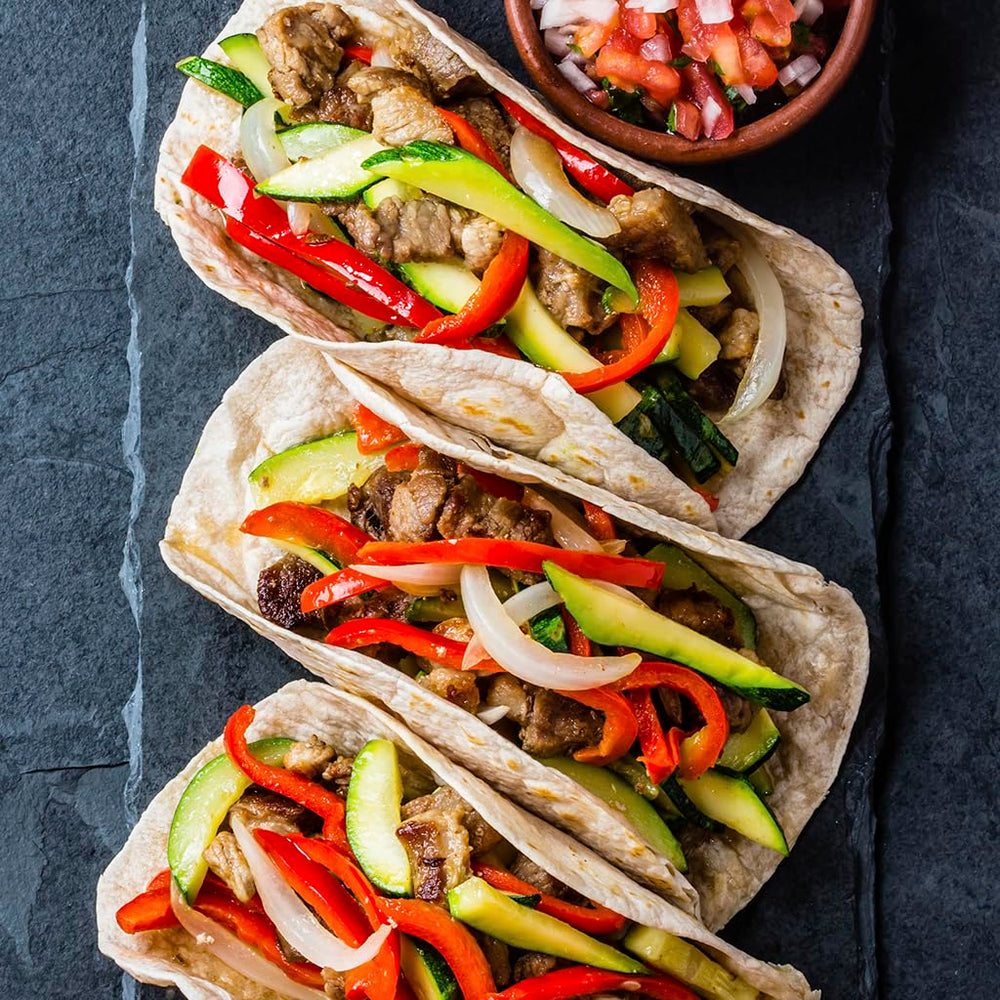 Family serving Ortega-fajita dinner at table showcasing crowd-pleasing flavor