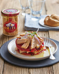Ortiz jar next to a lemon and fork for scale, illustrates serving portion and jar size