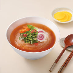 Ottogi pouring steaming kimchi beef broth into cup for fast meal benefit