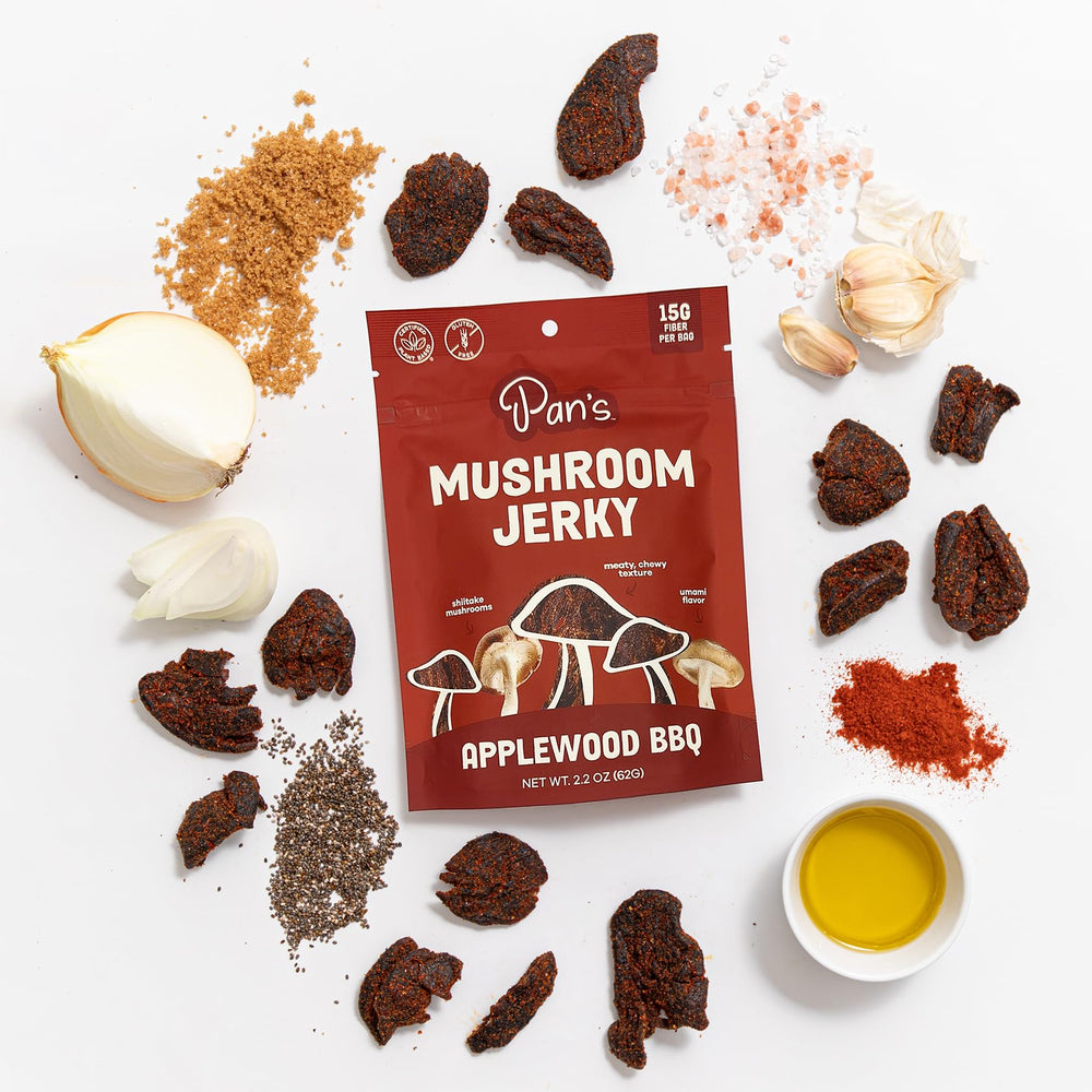 Pan's single jerky strip held by hand showing chewiness and satisfying bite