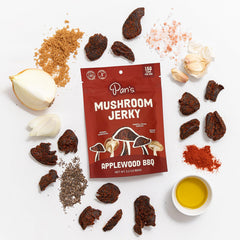 Pan's single jerky strip held by hand showing chewiness and satisfying bite