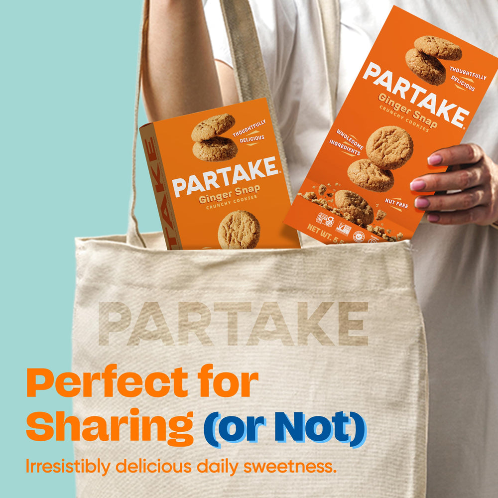 Hand holding a Partake cookie for scale showing portable, grab-and-go convenience