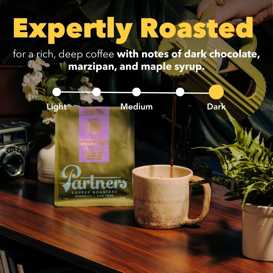 PARTNERS COFFEE ROASTERS close-up of dark whole beans highlighting rich surface oils and texture for flavor