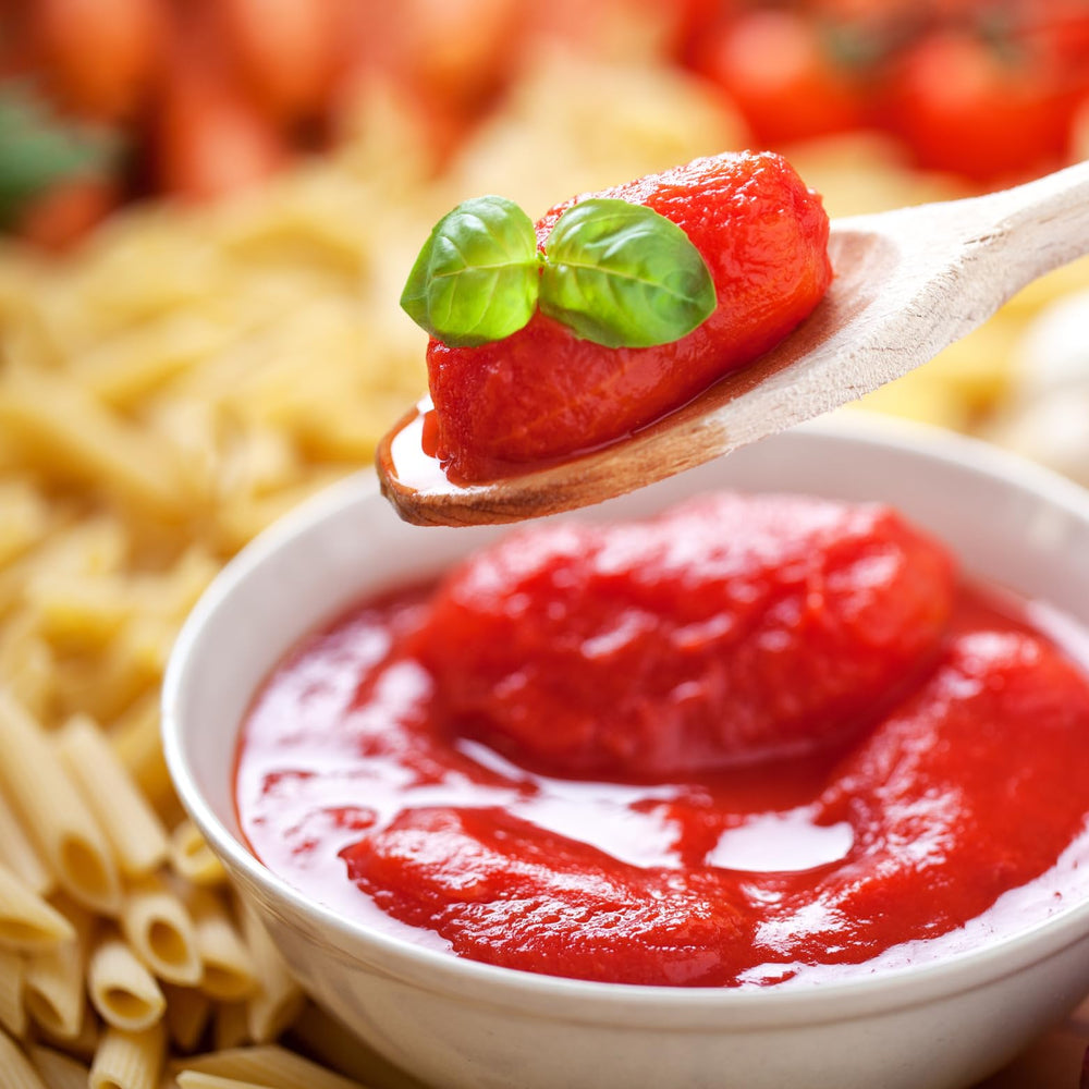 Pastene open can top view revealing ground tomatoes and rich juice