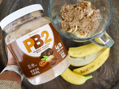 PB2 cocoa mixed with milk in glass for smooth chocolate-peanut shake