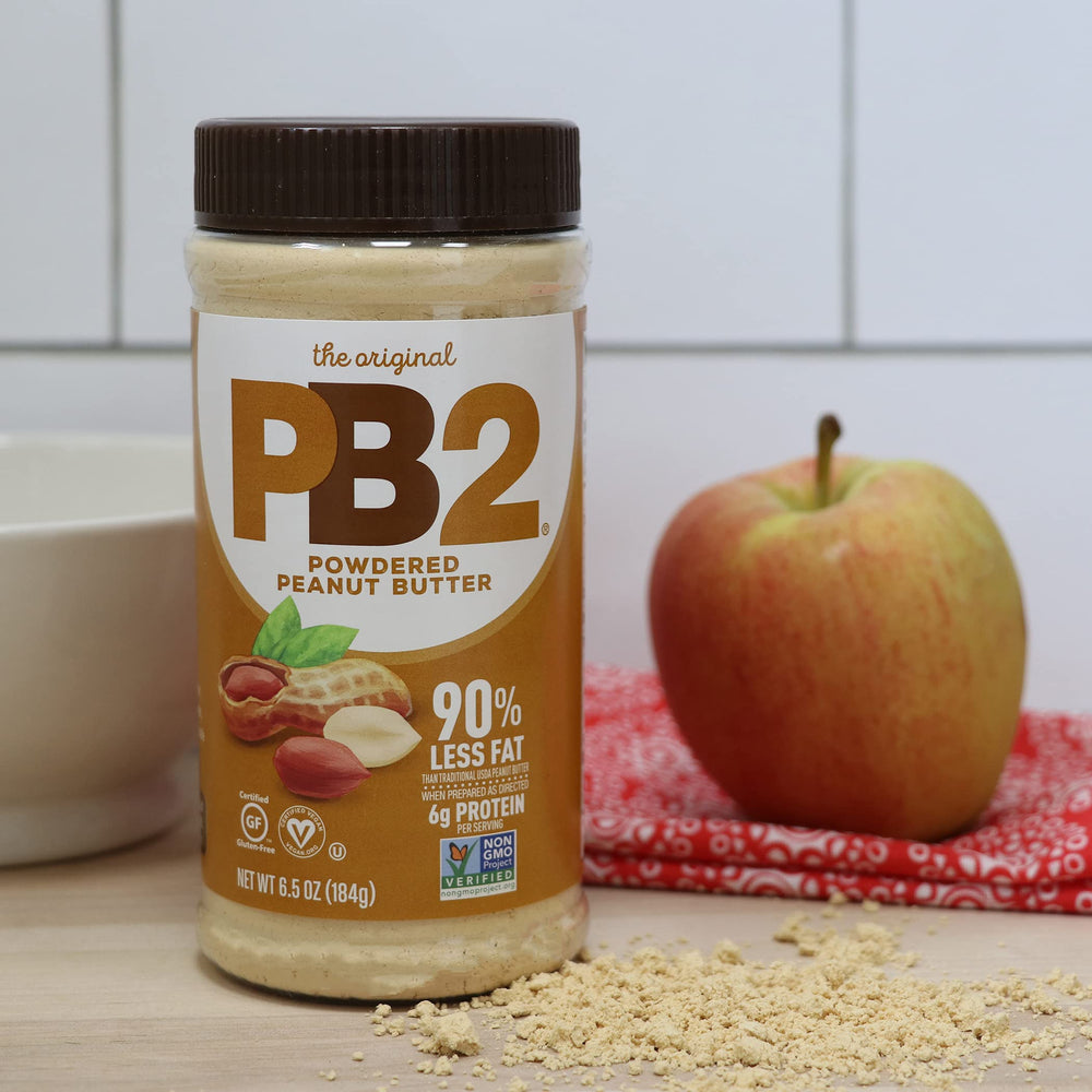 PB2 jar beside measuring utensils showing portion control and low fat
