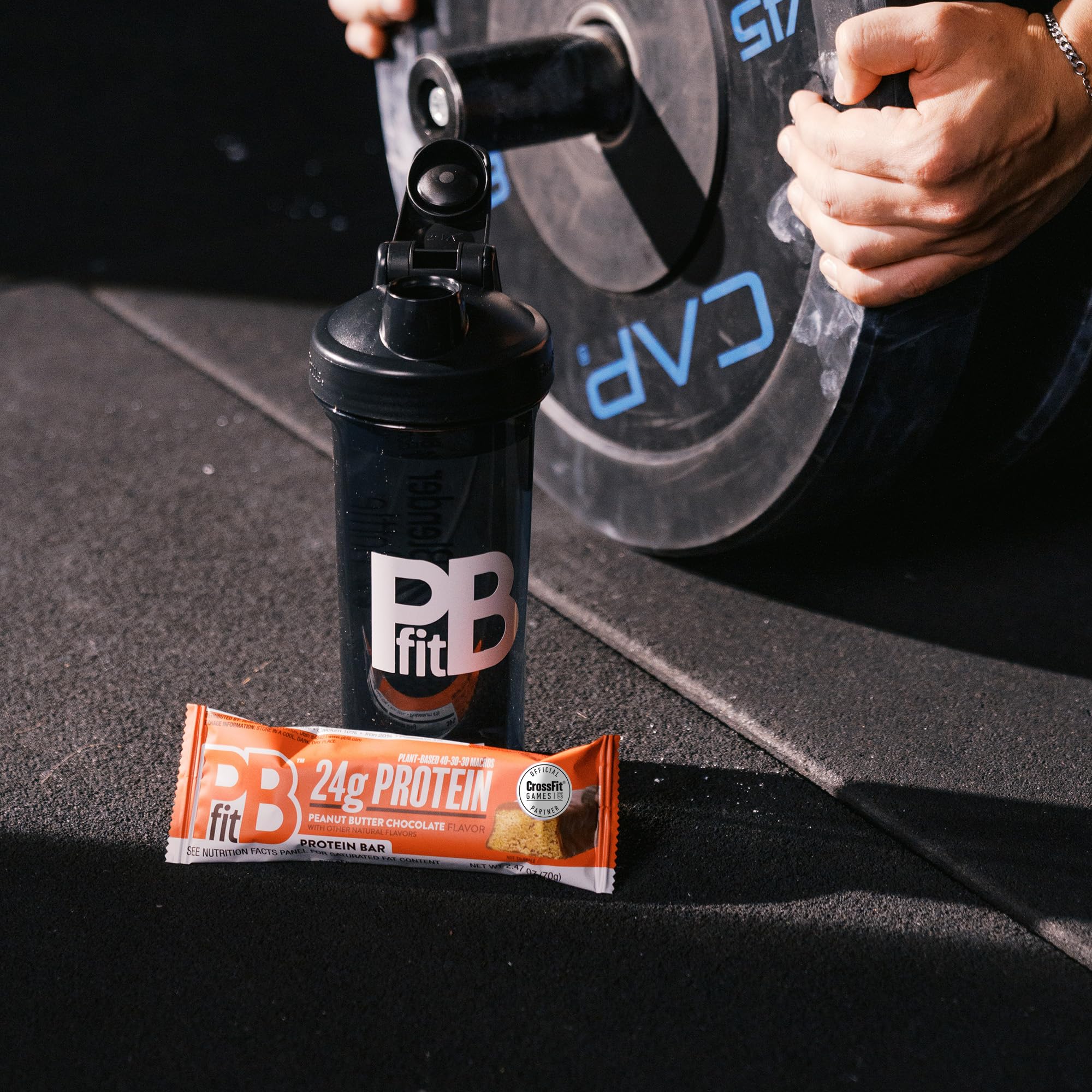 PBfit bar next to water bottle showing compact size and travel-friendly benefit