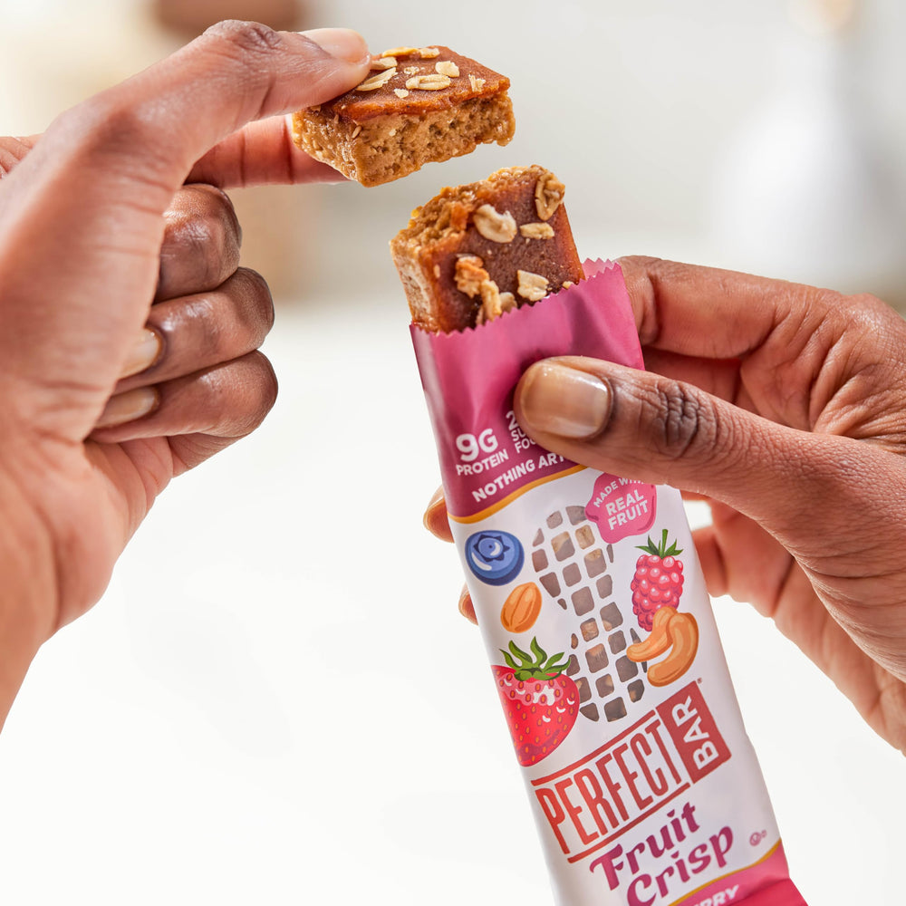 Perfect Bar held in hand to show portable size and convenient snack benefit