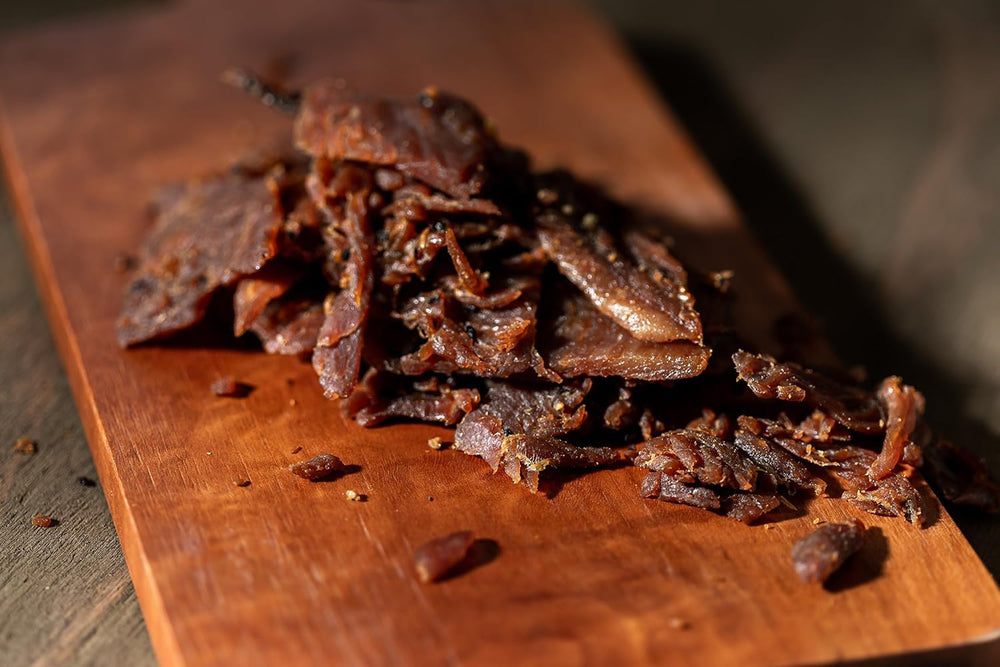 Perky Jerky portion displayed on wooden board showing serving size and shareability