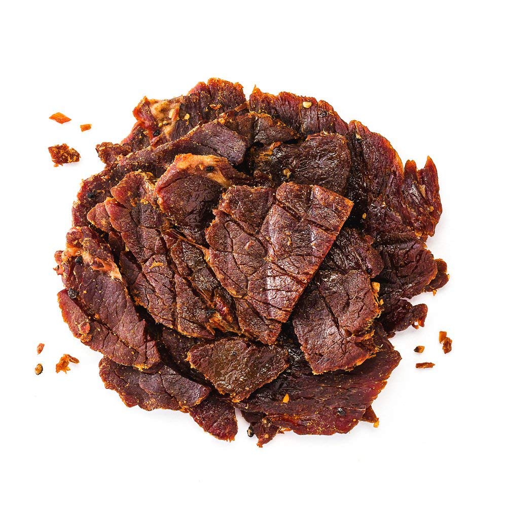 Perky Jerky resealable bag held in hand illustrating portability and freshness benefit