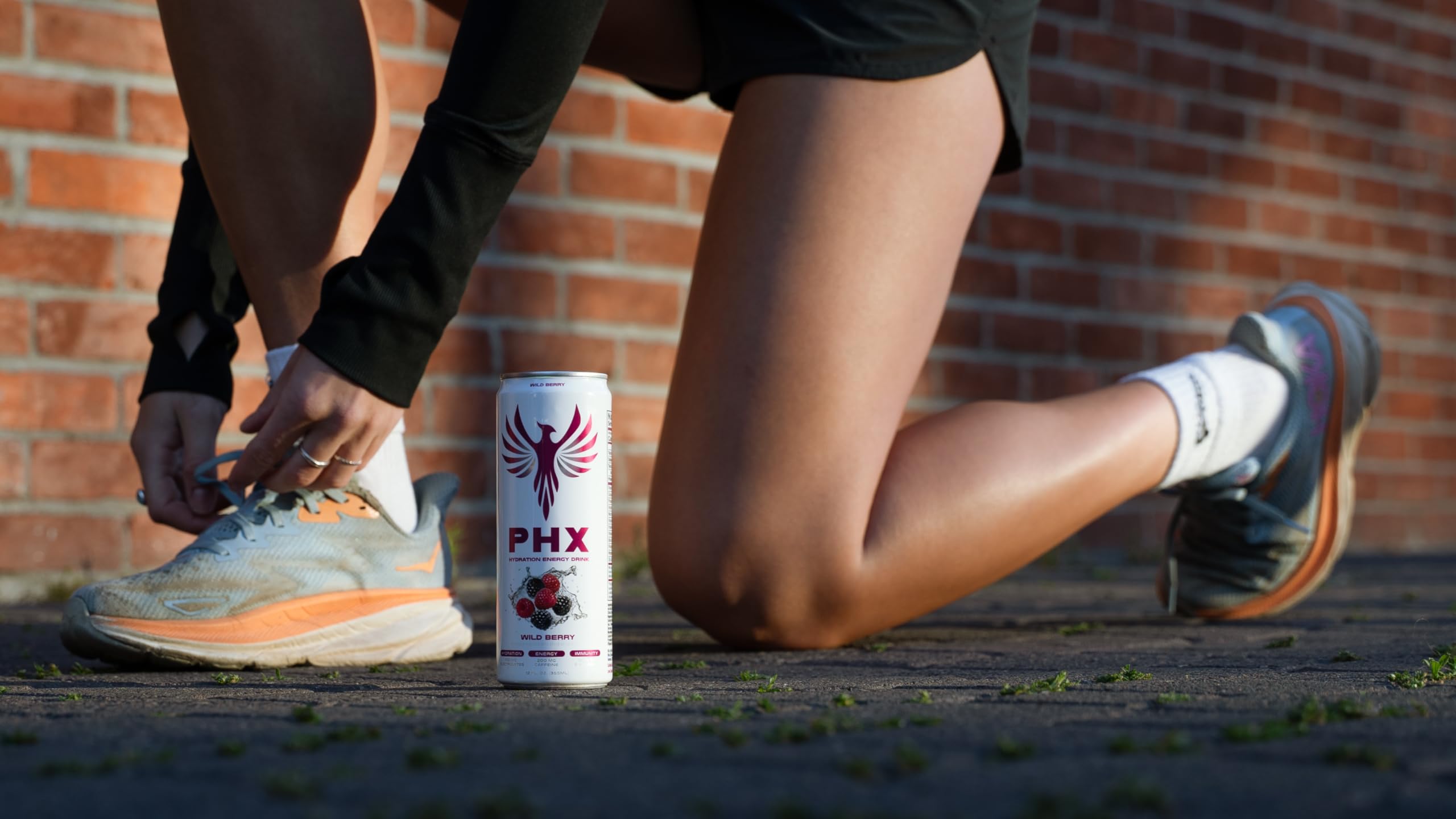 PHX athlete drinking Wild Berry after workout showing hydration and recovery