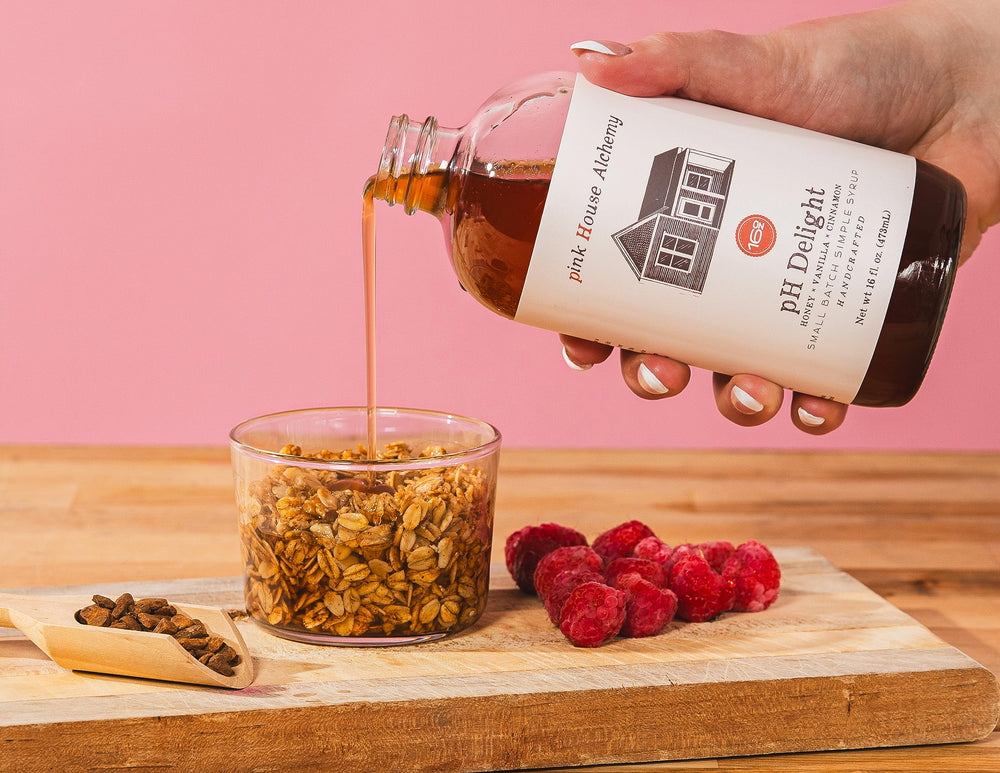 Pink House Alchemy syrup pouring from bottle showing texture and easy mixing benefit
