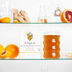 PIQUE ginger elixir served in a cup on a table conveying soothing post-meal comfort