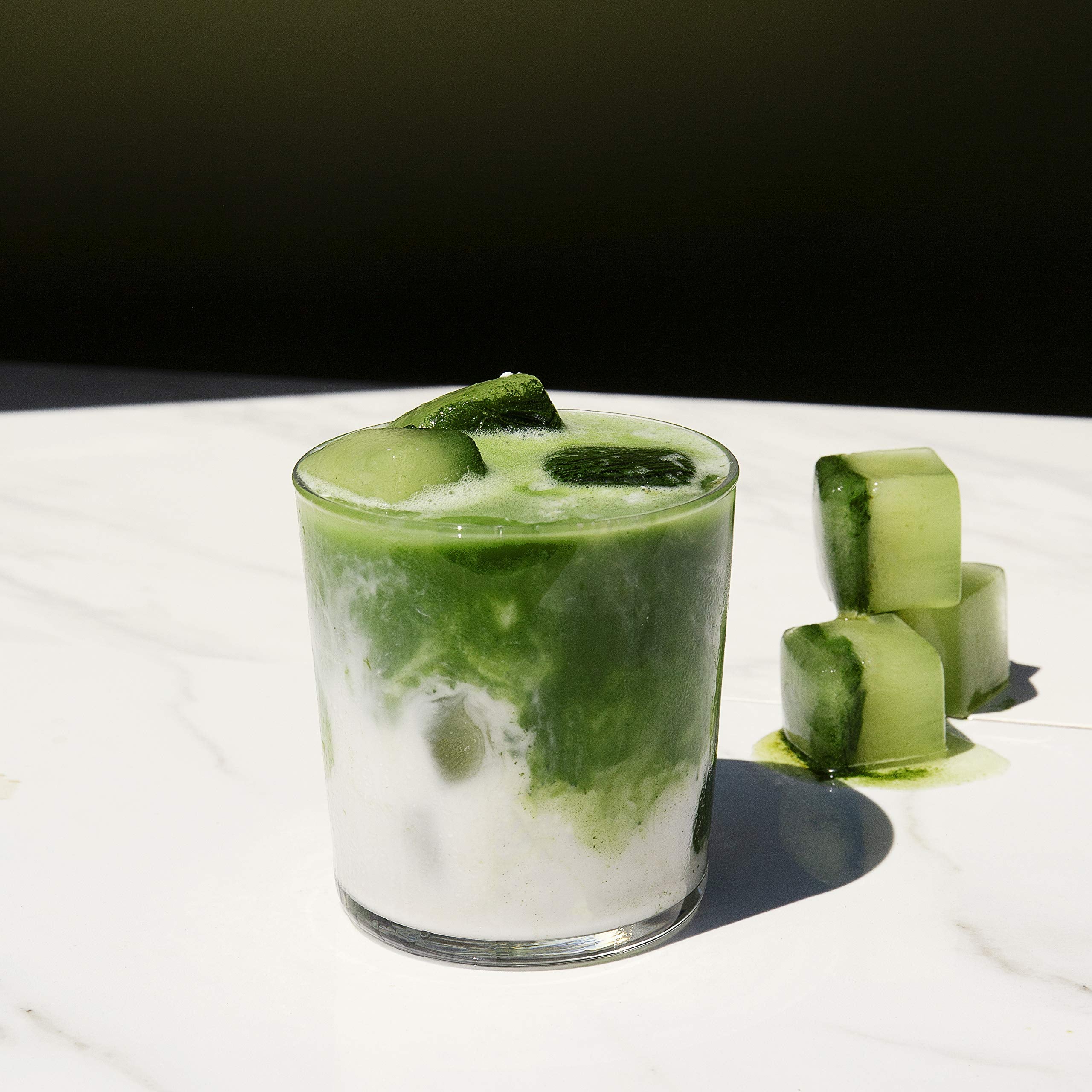 PIQUE matcha stick held in hand showing scale and travel-friendly size