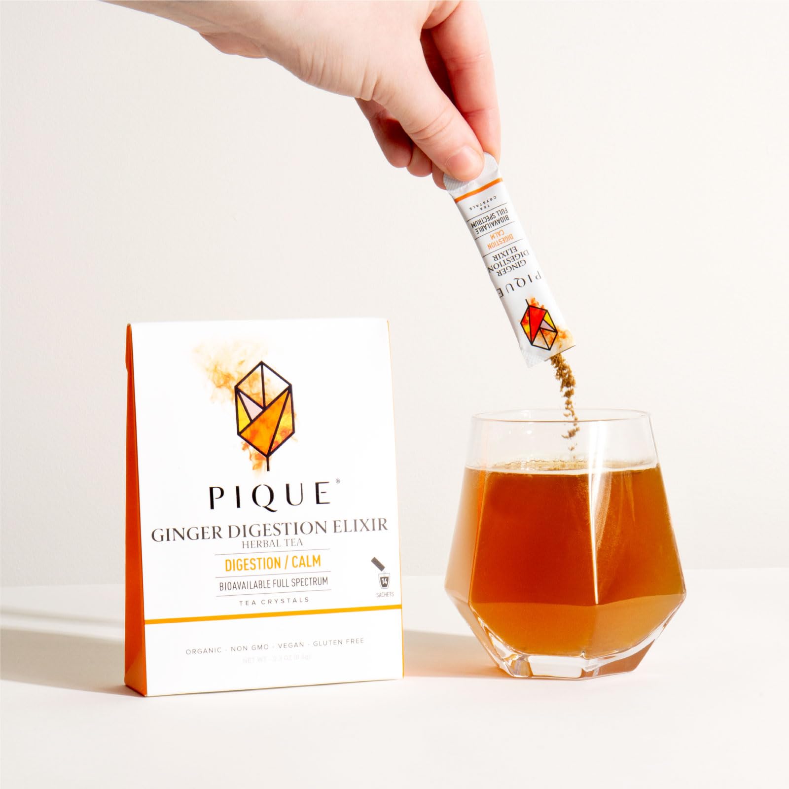 PIQUE single-serve stick poured into cup showing fast-dissolve ease