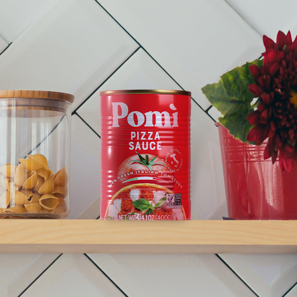 Pomì twelve-can pantry stack, illustrating bulk supply and kitchen readiness
