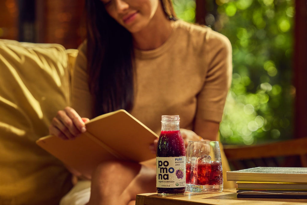 Pomona Organic blackberry juice poured into a glass illustrating vibrant color and ready-to-drink convenience