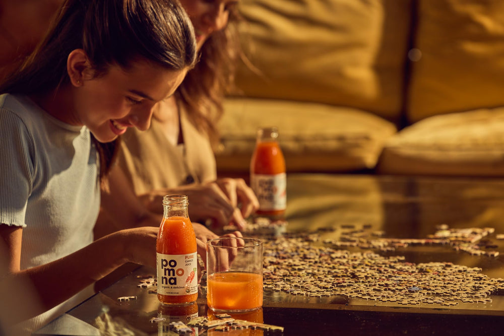 Pomona Organic juice poured into glass showing vivid color and ready-to-drink convenience