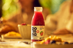 Pomona Organic pouring pink guava juice into glass for ready-to-drink refreshment
