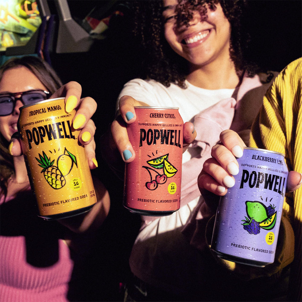 Popwell can next to hand for scale showing portable low-calorie option