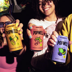 Popwell can next to hand for scale showing portable low-calorie option