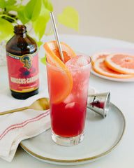 Portland Syrups bottle alongside a crafted cocktail illustrating mixology use