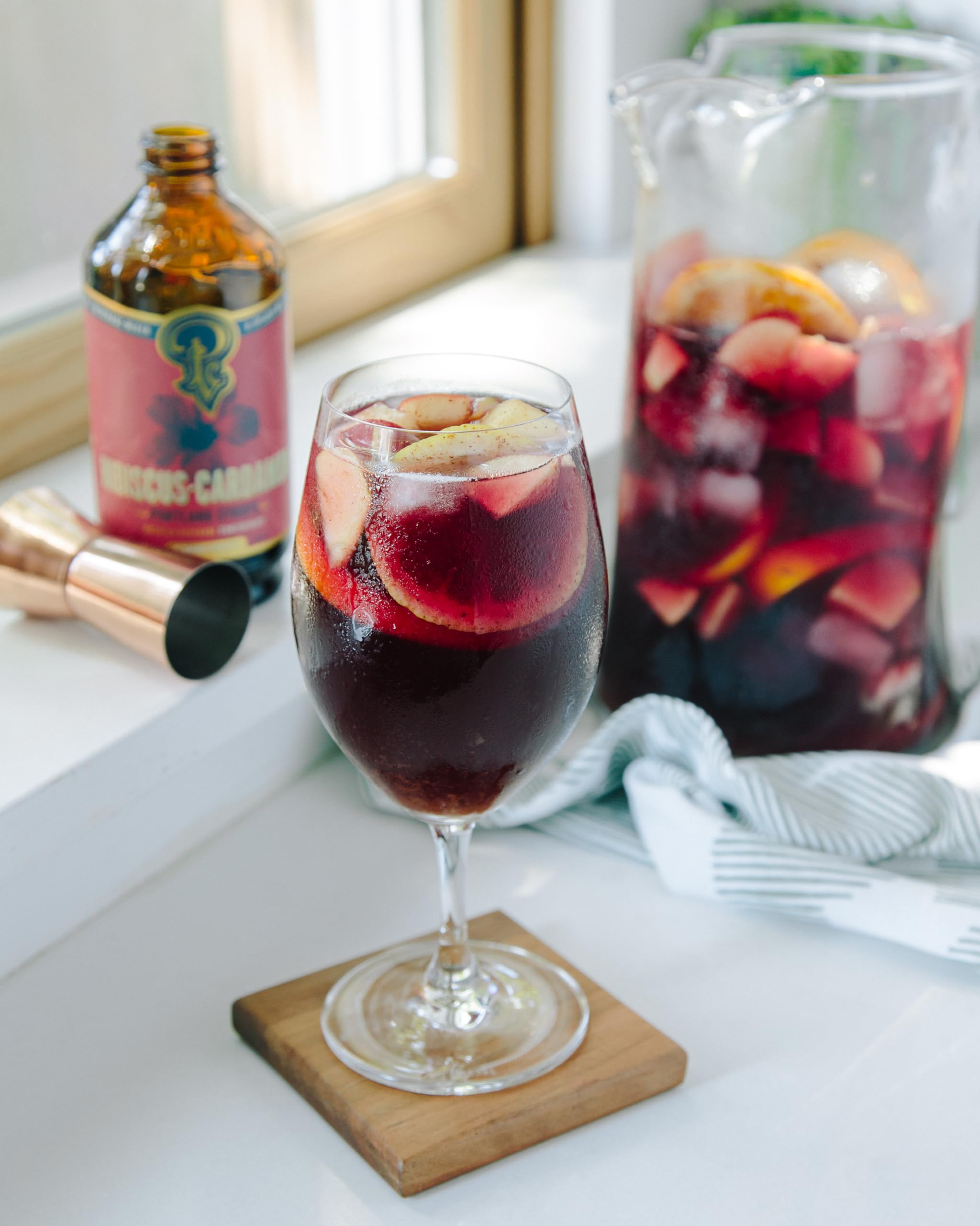 Portland Syrups with hibiscus flowers and cardamom pods displaying whole ingredients