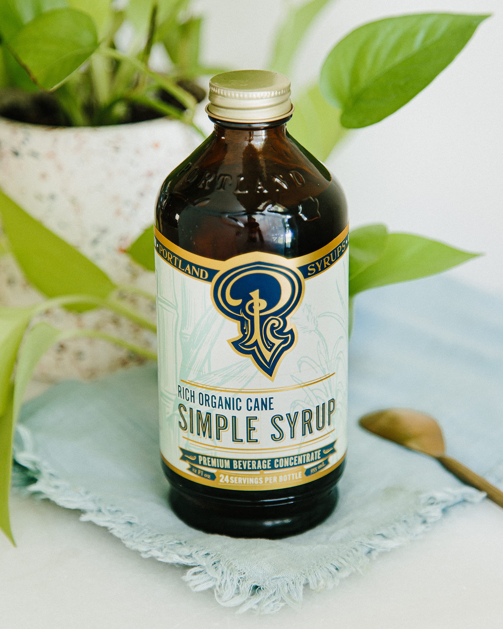 Two Portland Syrups 12 oz bottles beside a ruler to illustrate compact, economical size