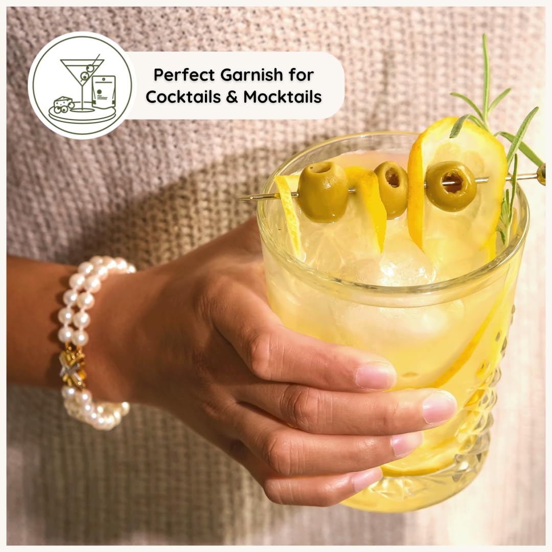 POSHI olives used as cocktail garnish, adds bright savory flavor
