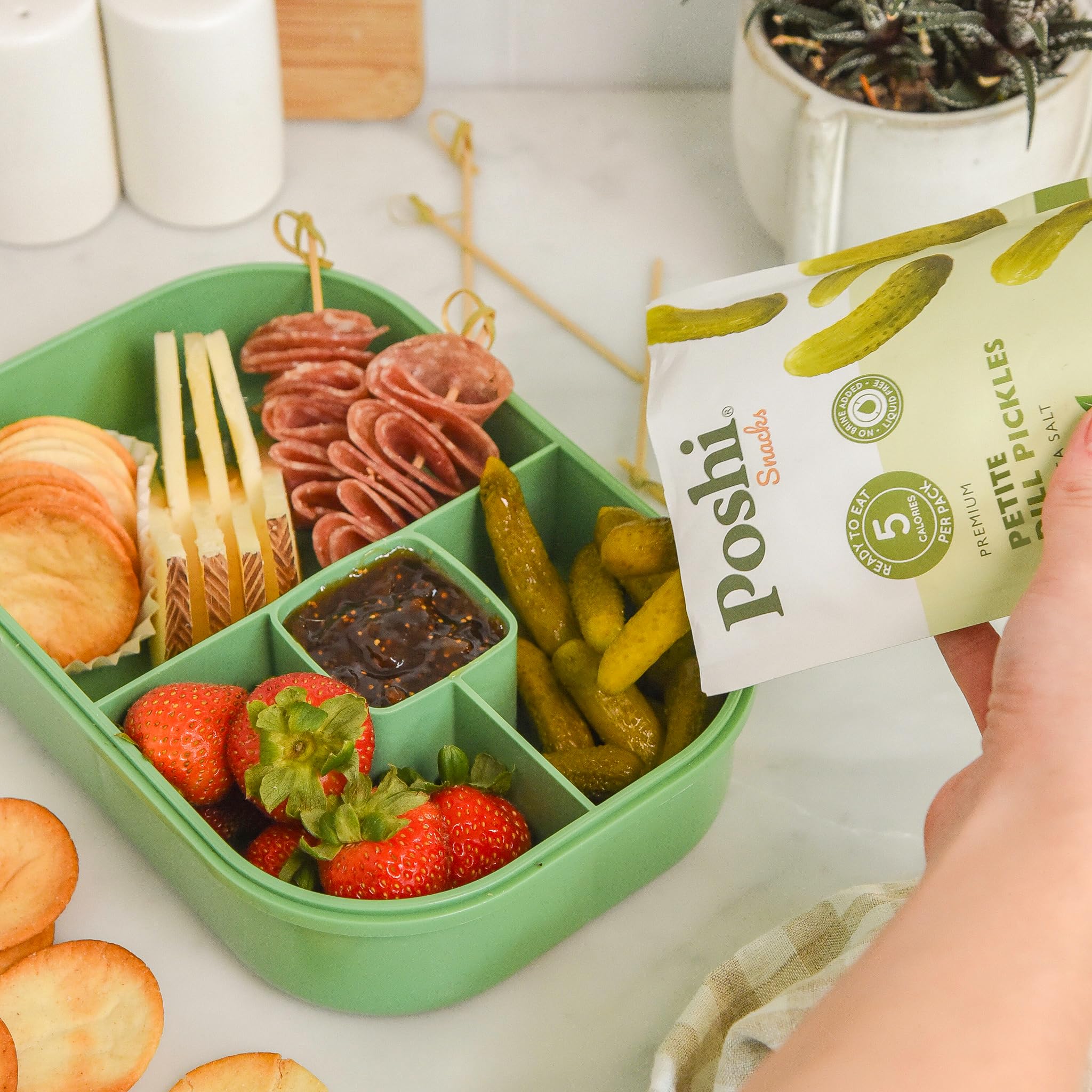 Poshi pouch placed inside a lunchbox offering portable snack convenience