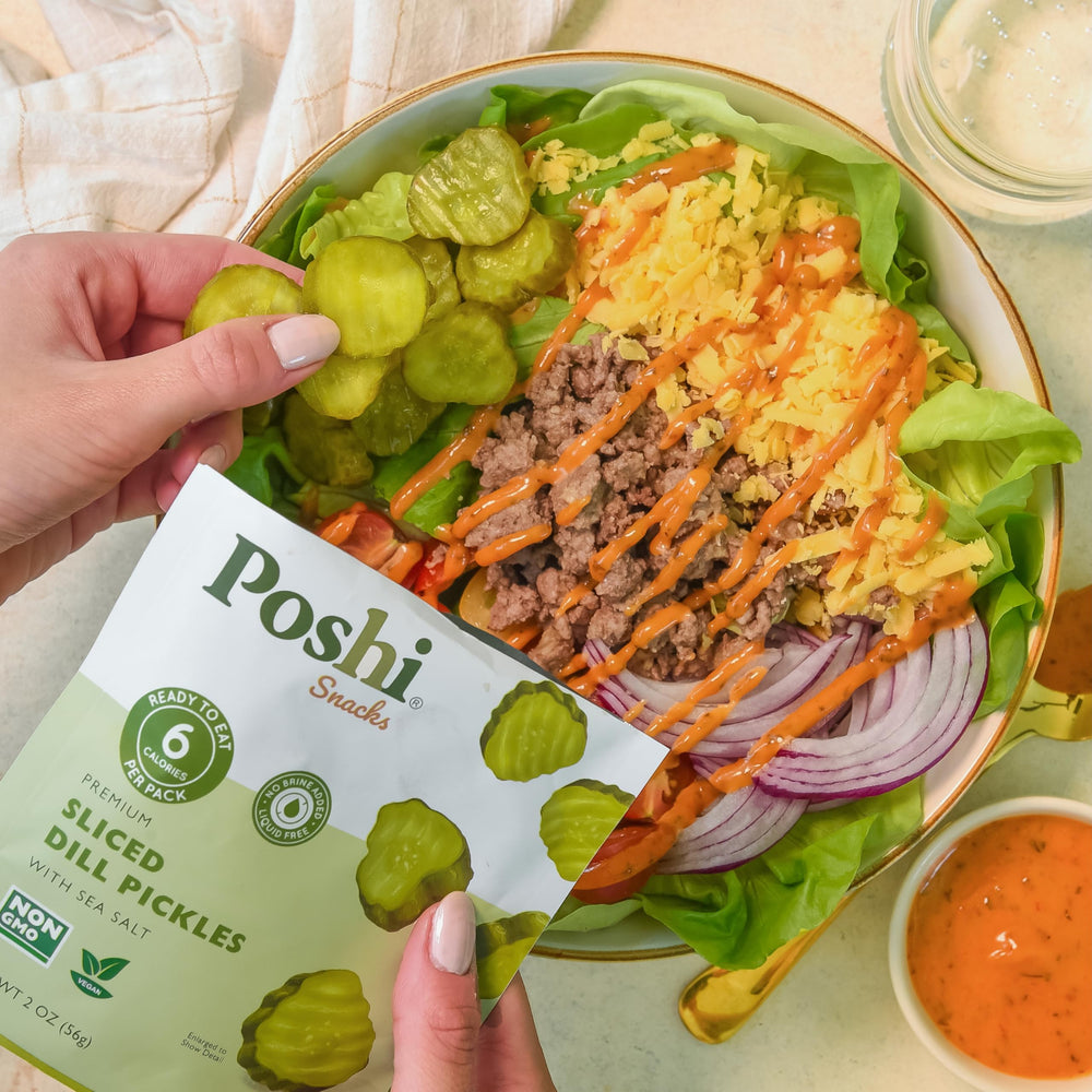 Poshi pouch beside soda can showing compact size