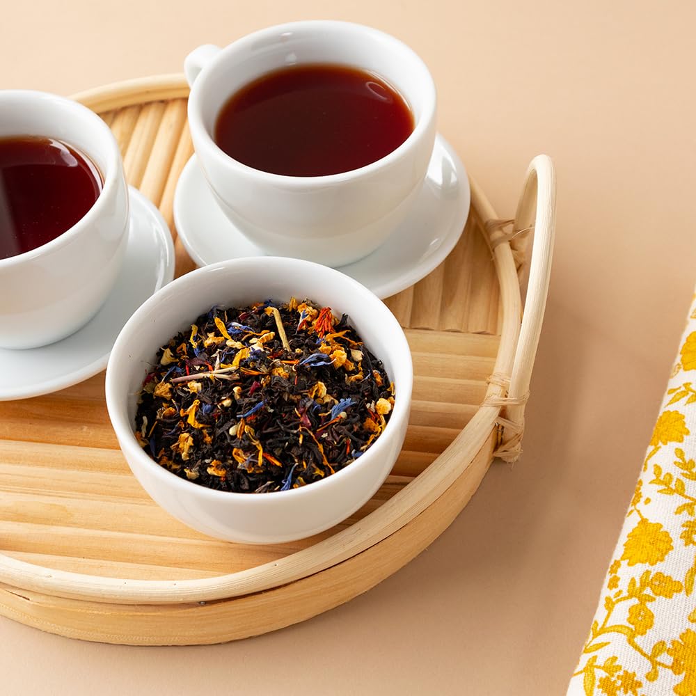 Iced pitcher of Positively Tea Paradise Black Tea served with ice and citrus for refreshing drinks