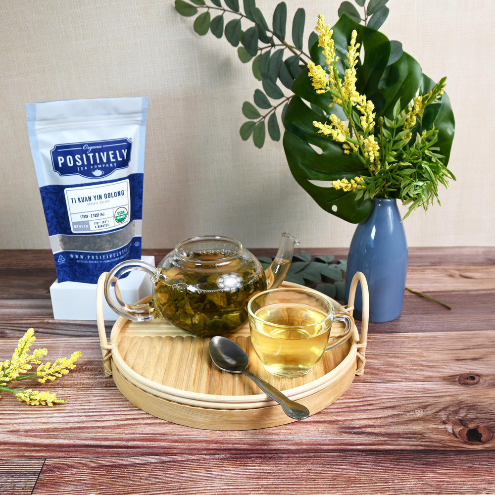 teapot pouring Positively Tea Ti Kuan Yin into cup illustrating serving and steeping clarity