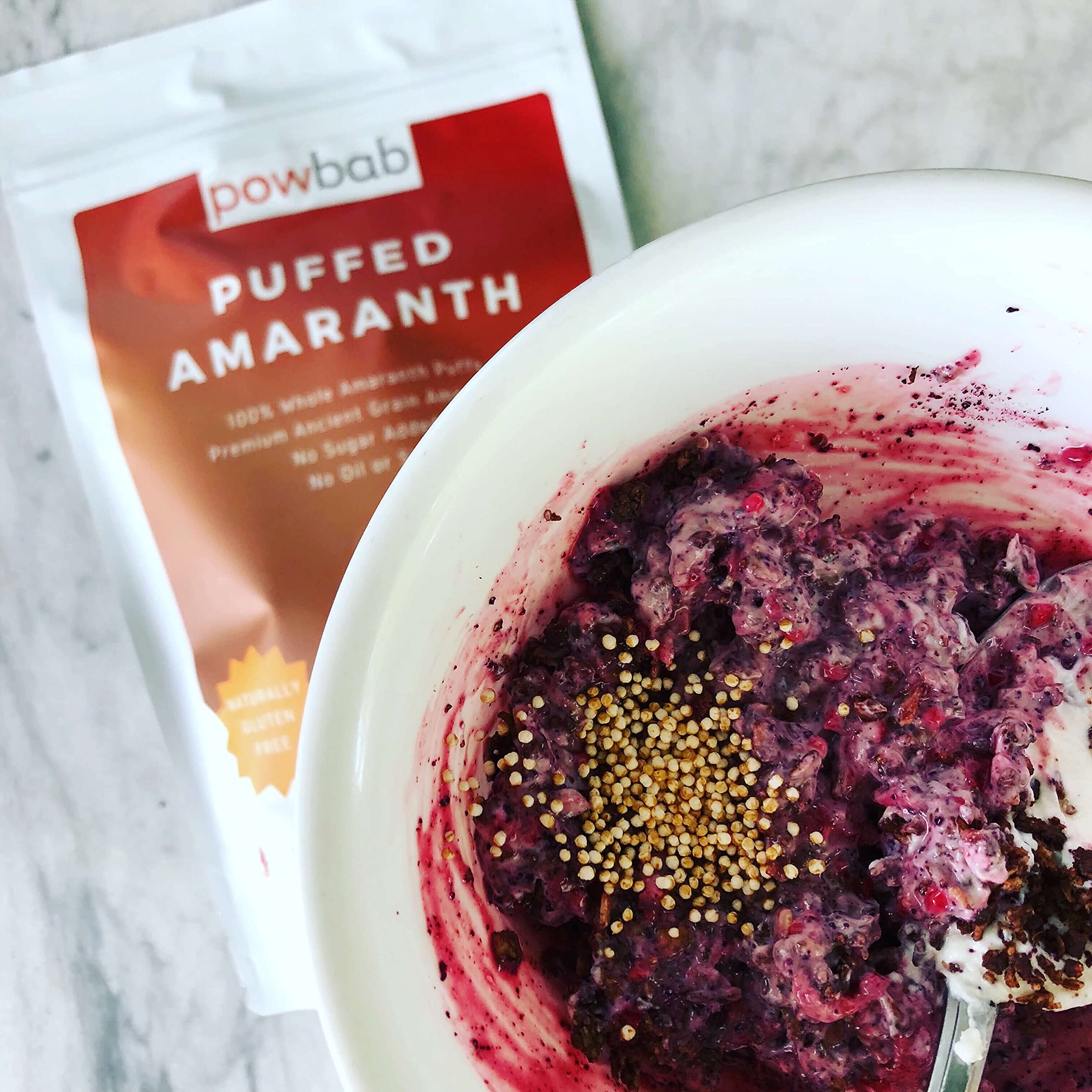 powbab puffed amaranth mixed into granola with dried fruit, boosts crunch and whole grains