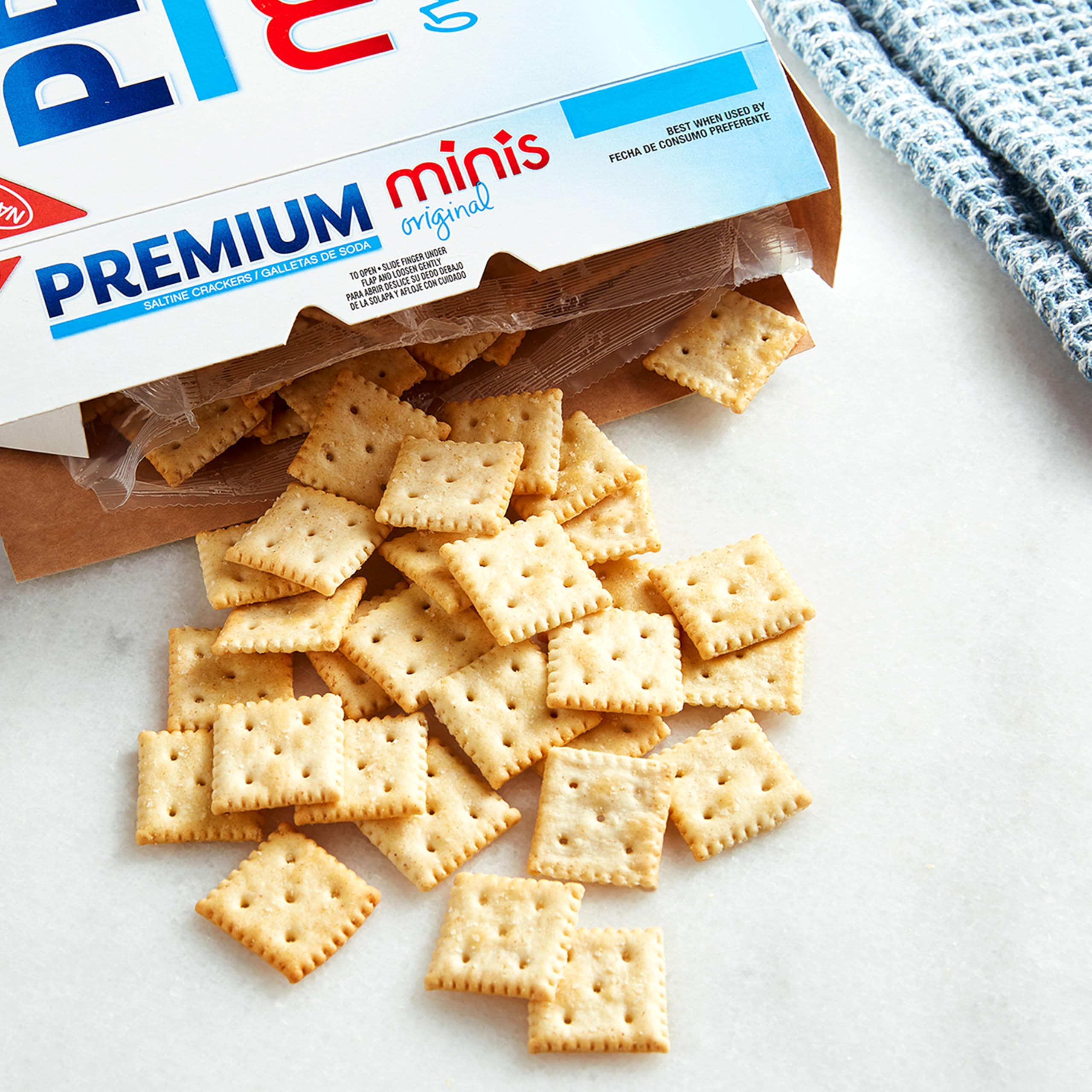 Premium mini saltine size comparison in hand showing bite-sized squares for portion control