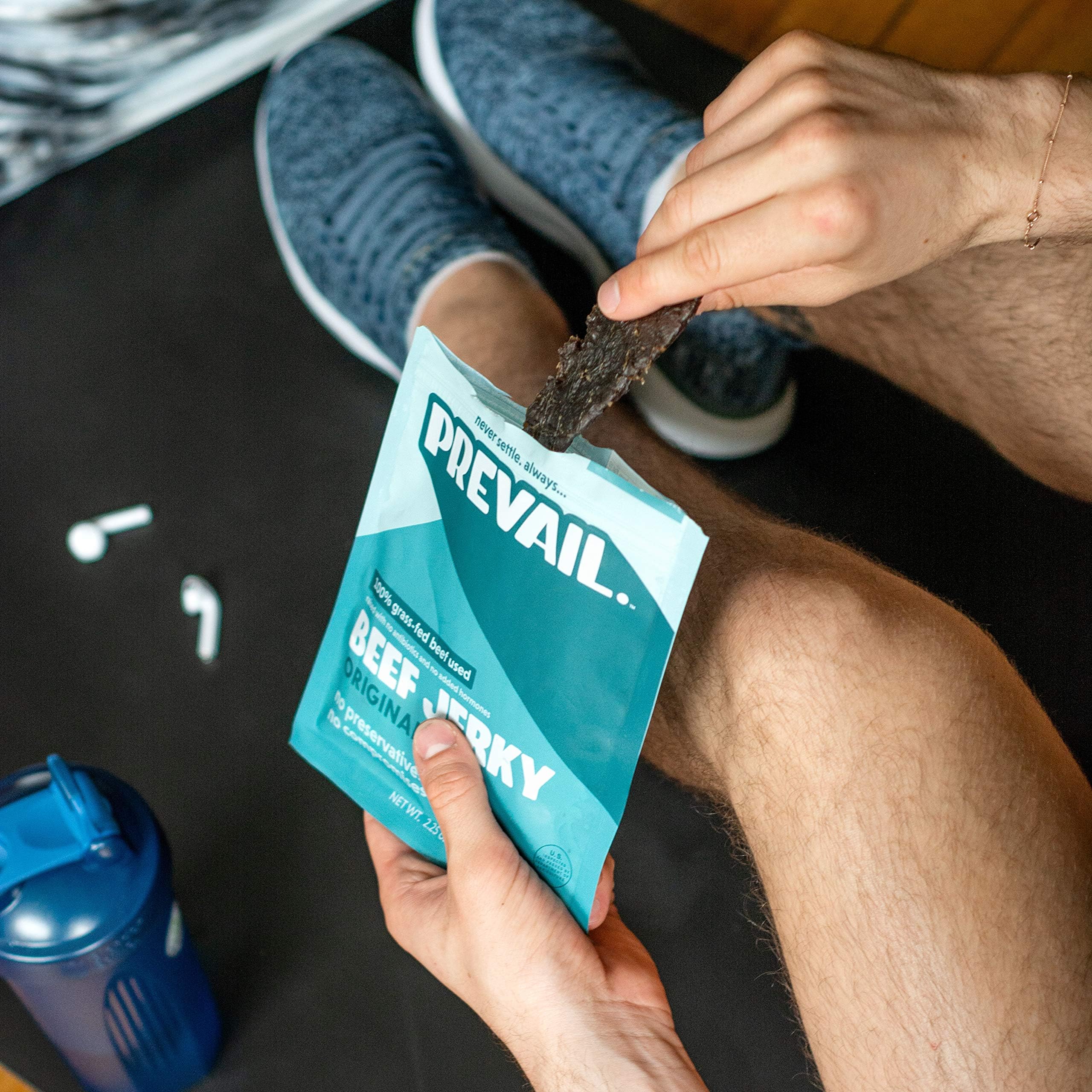 PREVAIL jerky beside coffee in lifestyle scene for on-the-go snacking