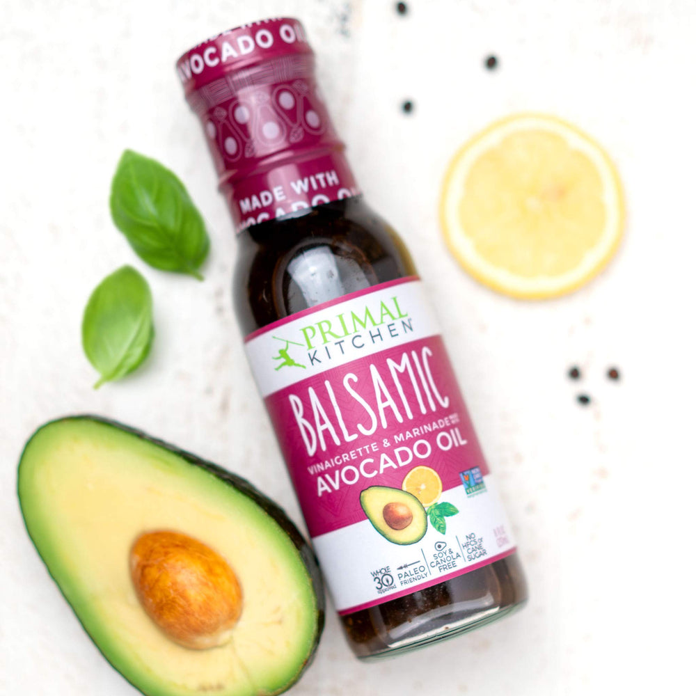 Primal Kitchen Balsamic Vinaigrette drizzled on salad delivering sweet-tangy finish benefit
