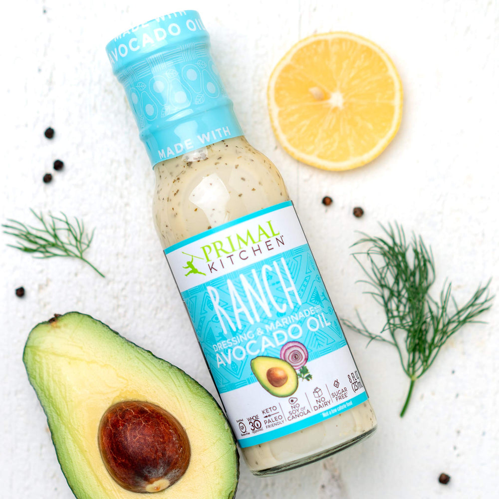 Primal Kitchen Green Goddess bottle angled to show herb-speckled, dairy-free formula