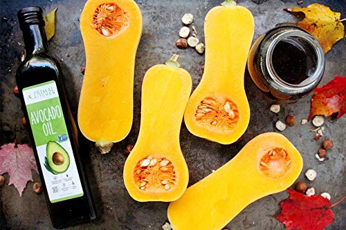 Primal Kitchen bottle next to a measuring cup to show 16.9 fl oz scale