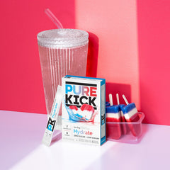 PURE KICK single packet opened beside a water bottle for quick use