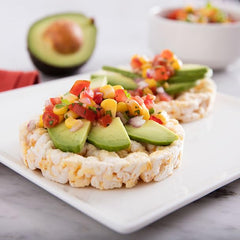 quaker rice cakes topped with avocado and tomato for tasty convenience