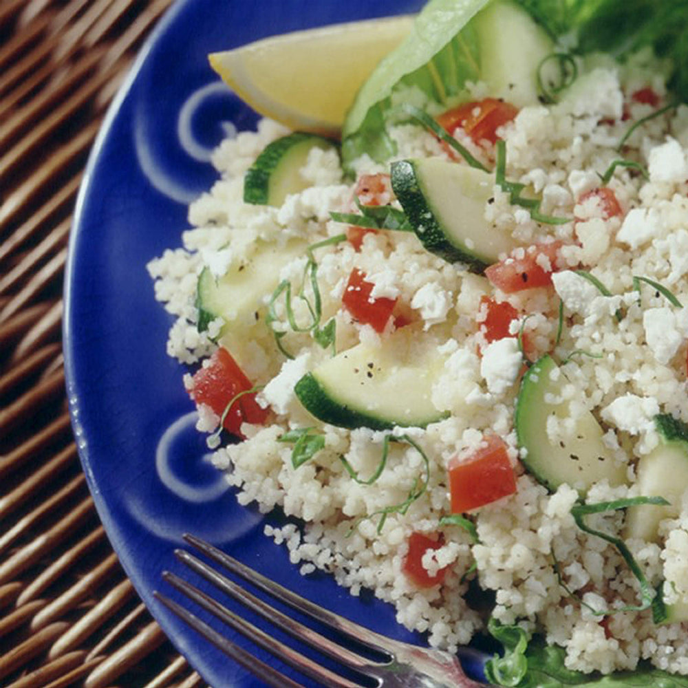 Quaker Near East tabouleh served on a plate with tomato and lemon, ready-to-eat refreshing side