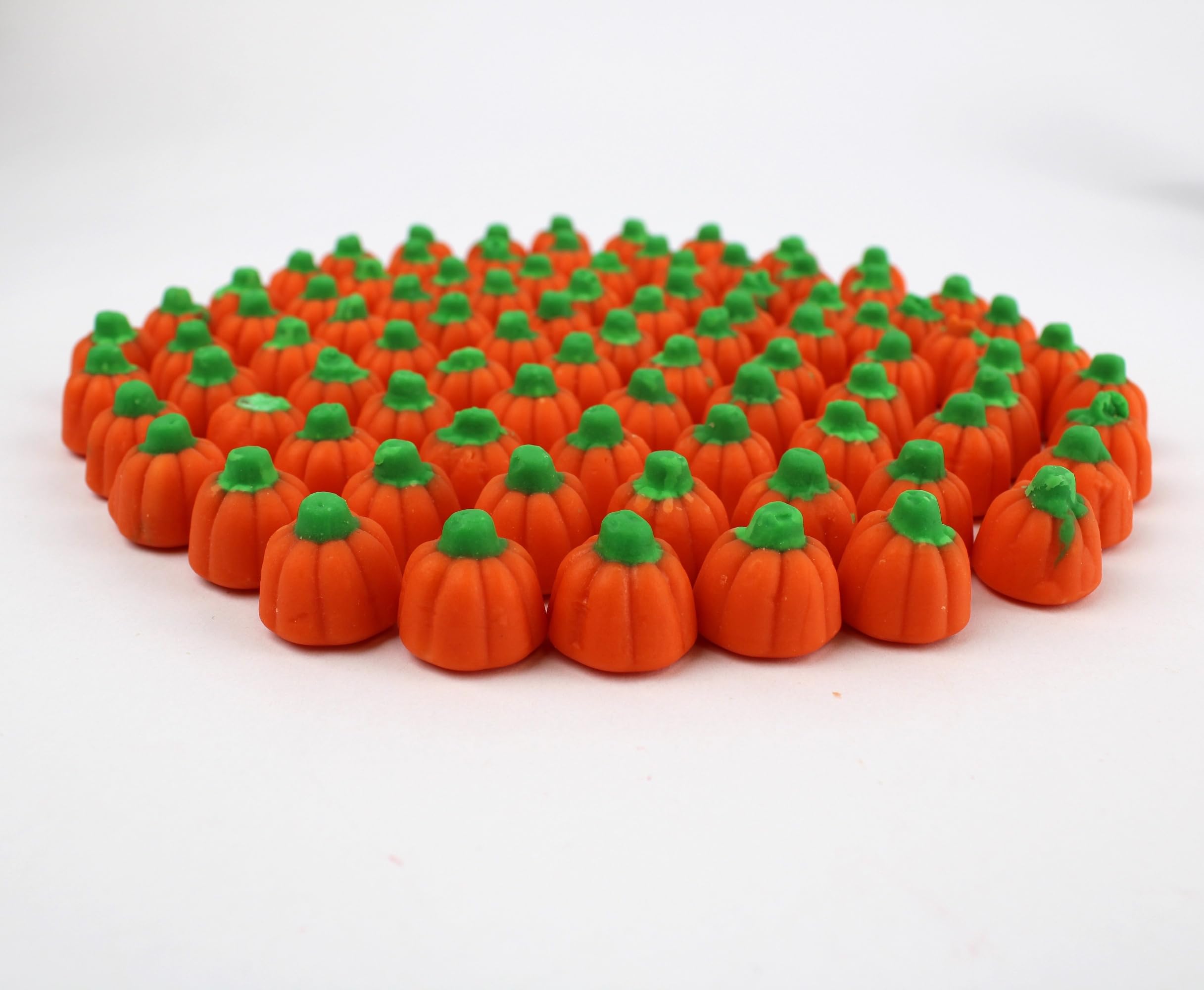 QUEEN CITY CANDY CAVE beside a ruler showing pumpkin candy size and scale