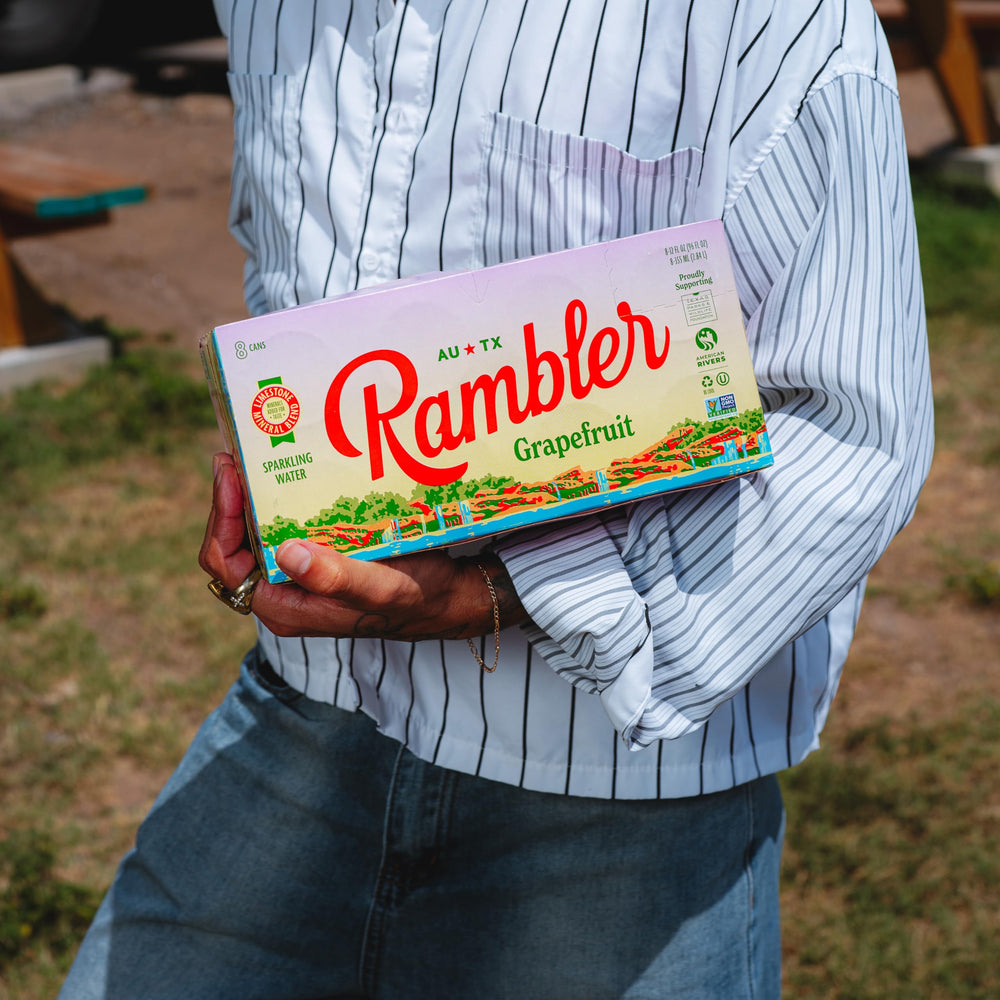 RAMBLER pouring into a glass with bubbles visible, delivering crisp hydration