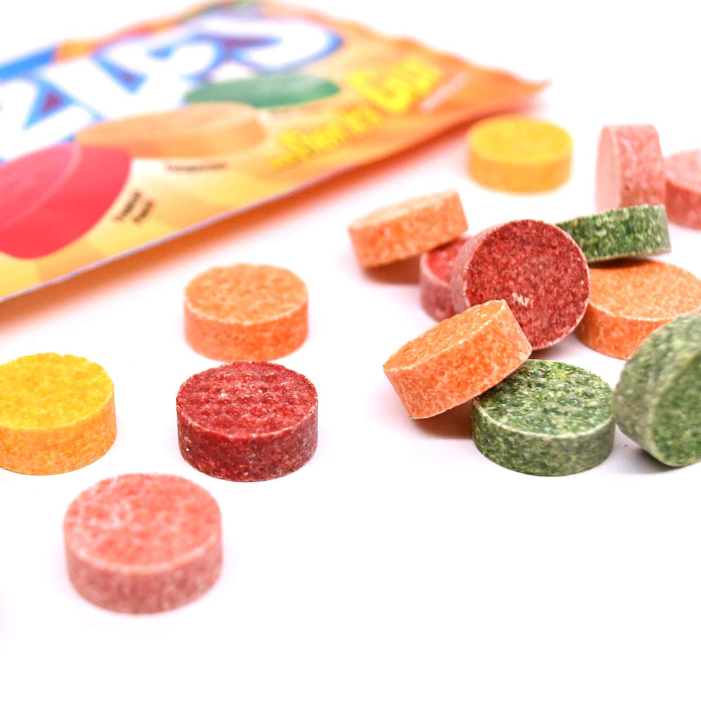 Hand holding a Razzles Tropical bag to show compact travel size