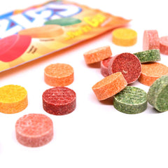 Hand holding a Razzles Tropical bag to show compact travel size