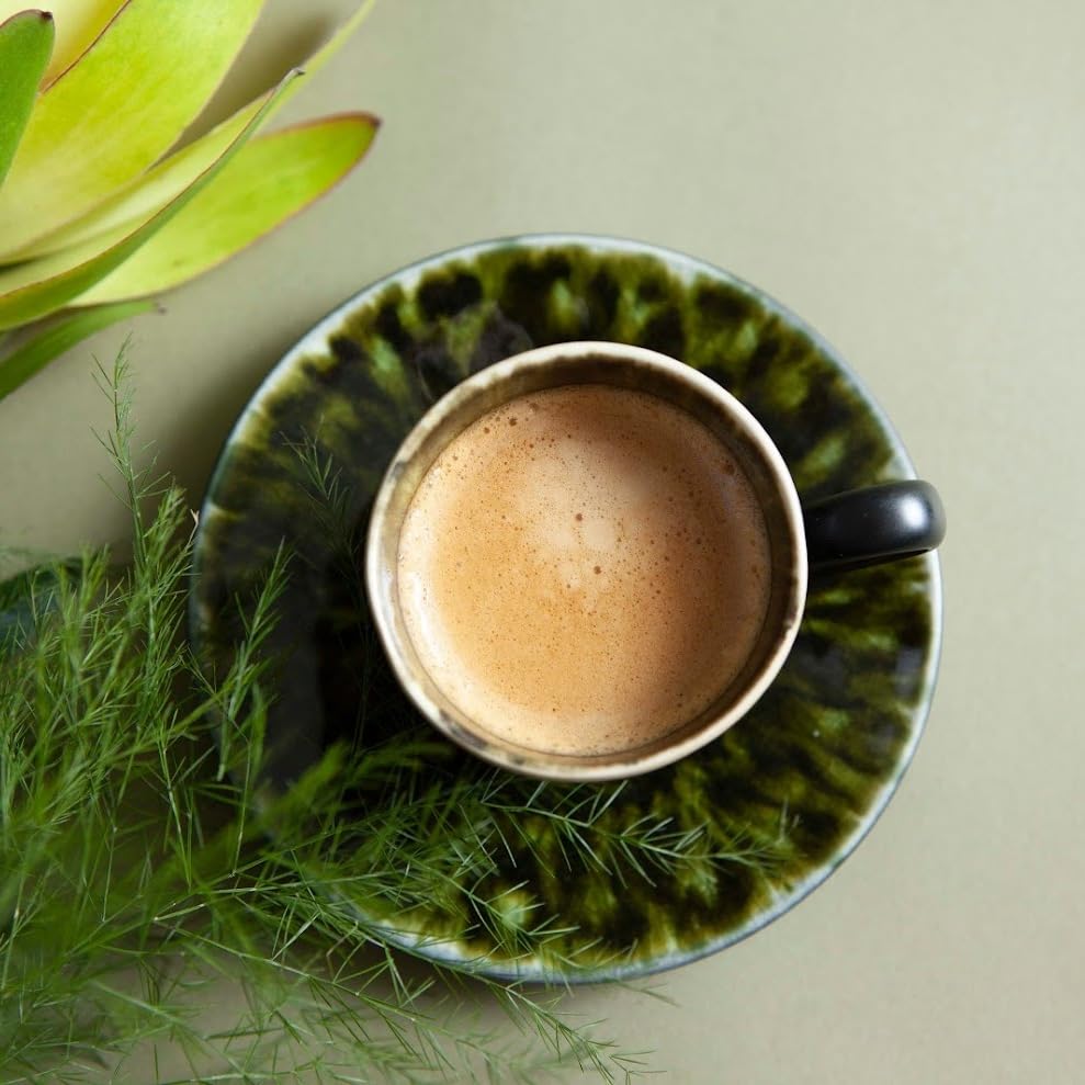 REAL COFFEE GREAT TASTE capsule next to a coin showing compact size and convenience